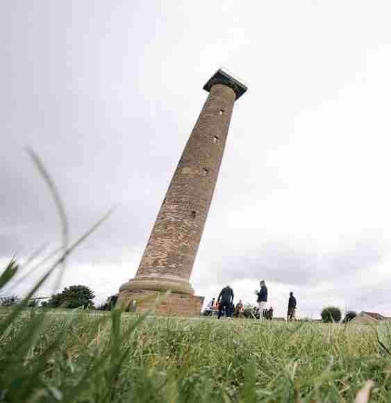 Keppel's Column, a tall stone column in a field. It is an overcast cloudy day.